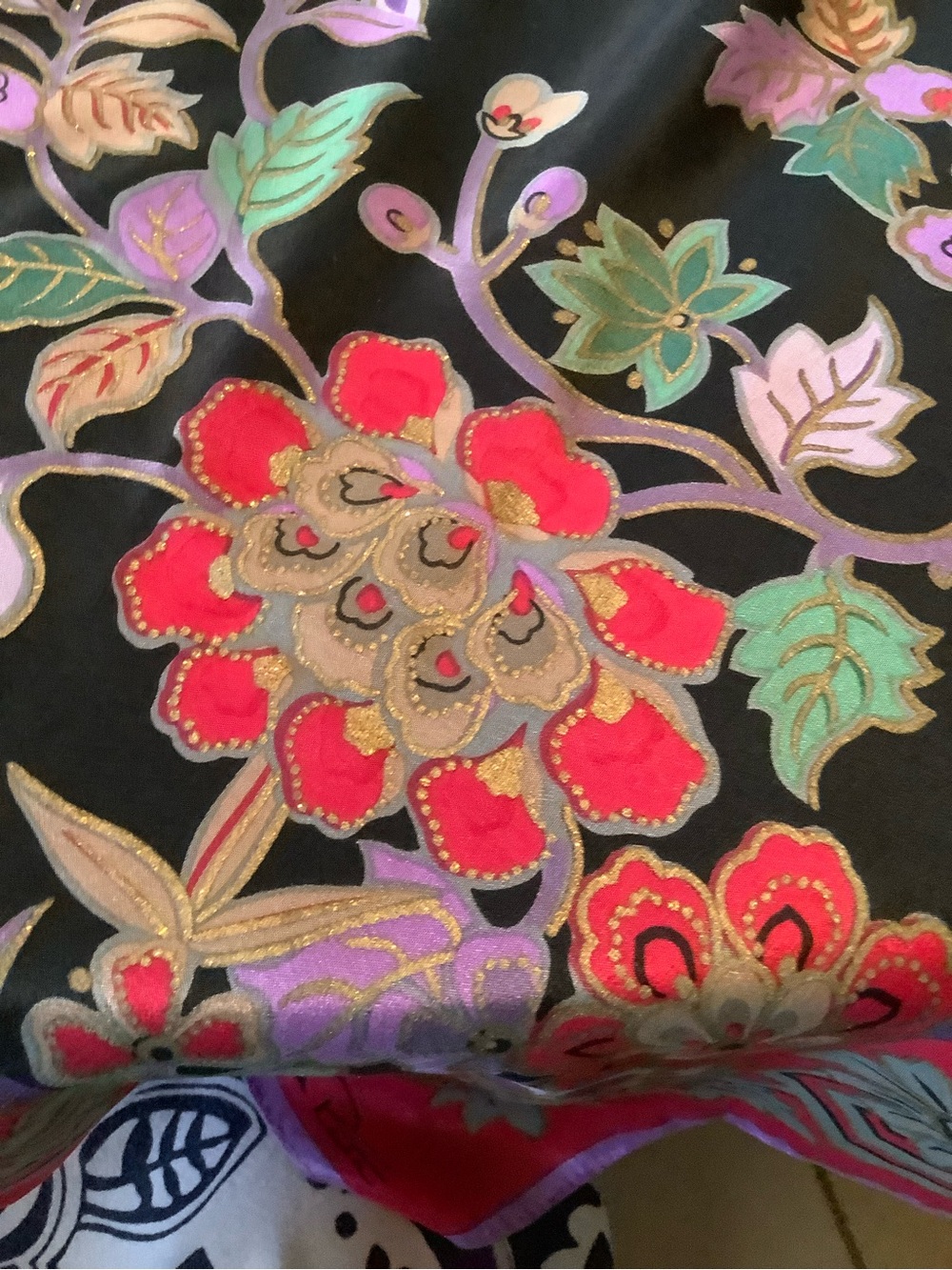 Floral silk print with Red and Green Accents and Gold touches. 34” square.